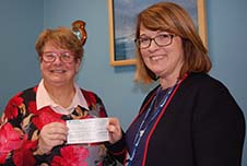 Cllr Farmer (left) handing over a cheque to Mind In Mid Herts Chief Executive Sharn Tomlinson.