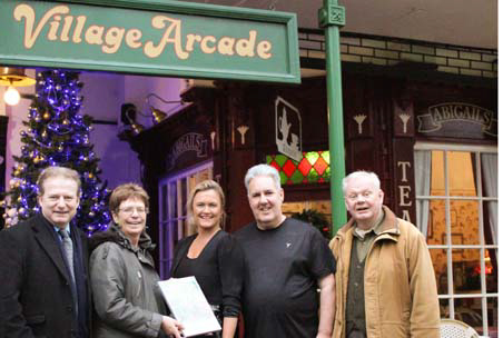 Brian Dawkins and Wendy McCarthy of the Village Arcade accept their award from the judges
