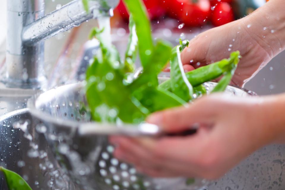 Cleaning vegetables in a sink