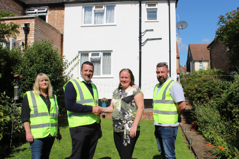 Cllr Jacqui Taylor, 3rd from left, shakes hands on the £18 million deal with CCS’s Danny Gladwyn, 2nd from left, at the Breakspear Avenue property with, far left,  Tina Harvey, CCS’s Senior Resident Liaison Officer, and, far right, James Kendrick, CCS’s Retrofit Site Supervisor. 